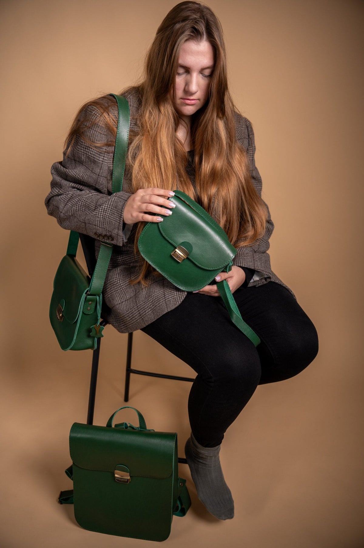 Zelma Kraft green leather handbags photographed with a model, showcasing Latvian leather design