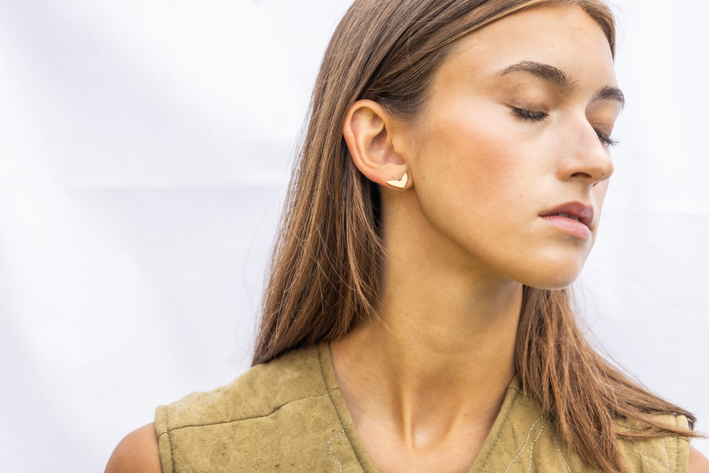 Minimalist gold earrings Scandinavian design close-up