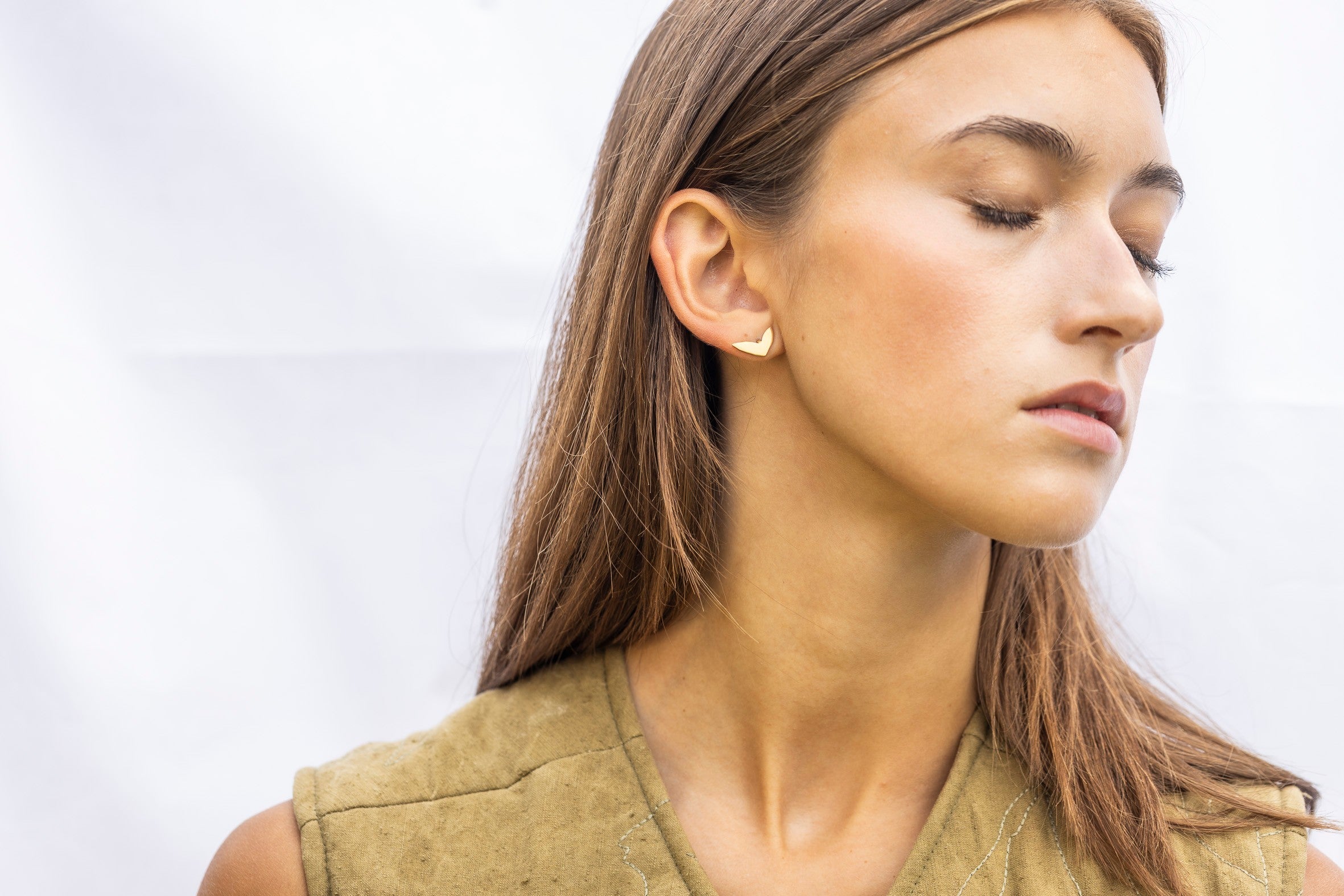 Minimalist gold earrings Scandinavian design close-up